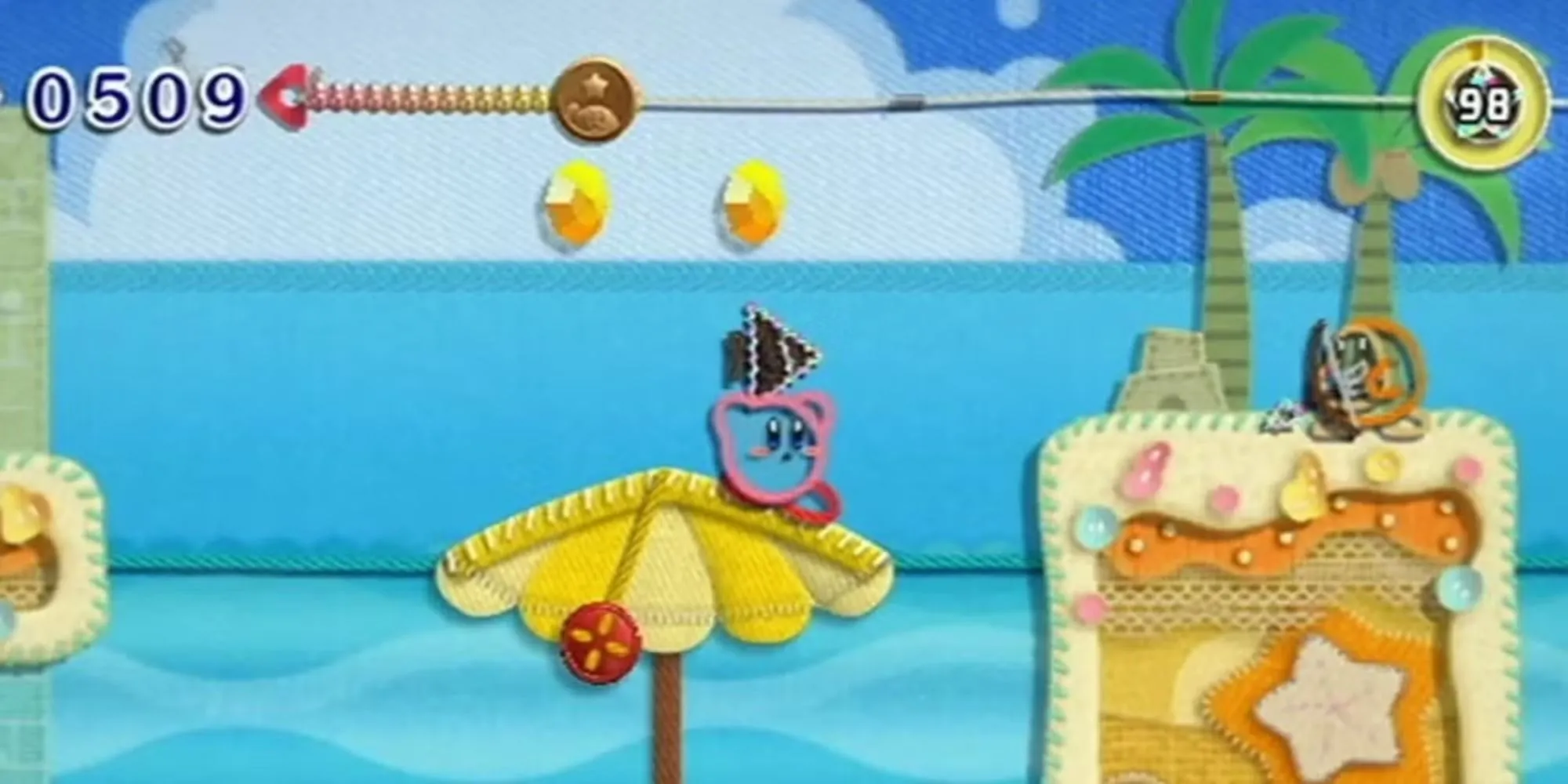 Kirby ngắm bắn cung vào Waddle Dee trong platformer nghệ thuật Kirby's Epic Yarn
