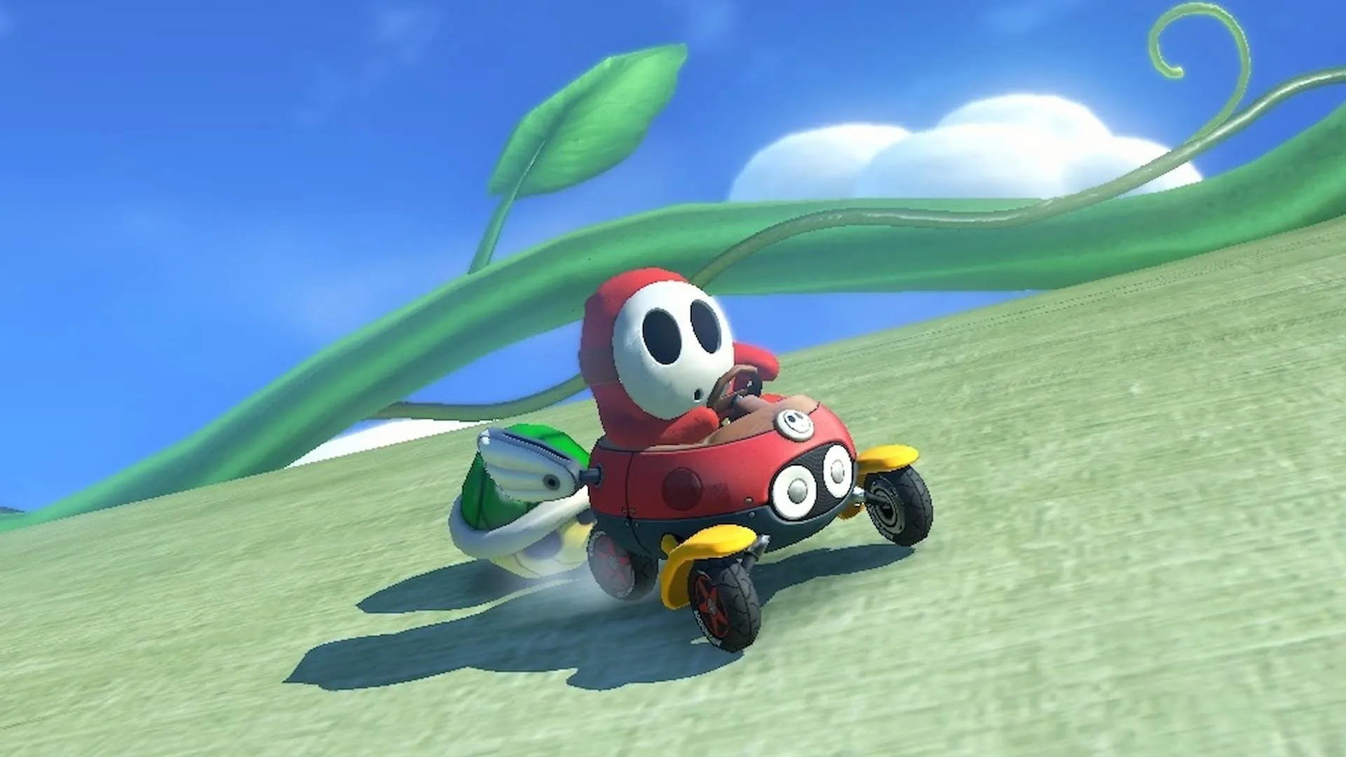 Shy Guy Đỏ bị Rùa Xanh truy đuổi trong Mario Kart 8 Deluxe